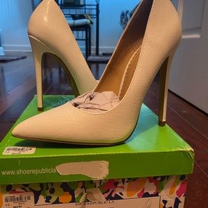 All white textured pumps